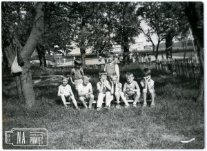 Koniec lat 80. Chłopcy siedzący na ławce na terenie przedszkola, w tle boisko szkolne